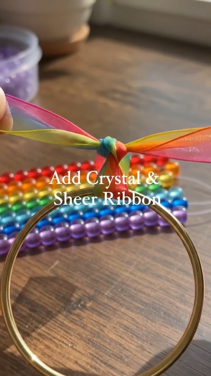 A mix of colorful pony beads and a crystal pendant creates a cheerful rainbow suncatcher that brightens any sunny window.