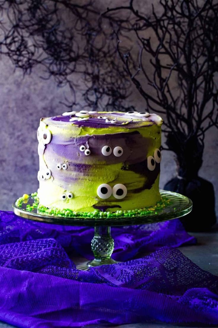 Monster Halloween Cake with Neon Green Frosting and Giant Eyes | Halloween smash cake 1st birthdays, Halloween themed cake with colorful frosting, Purple and green halloween cake