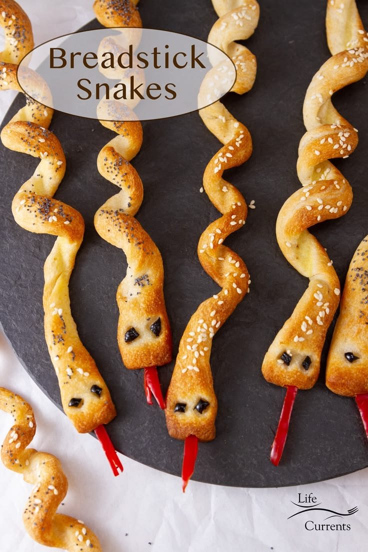 Spooky Halloween Breadstick Snakes are a perfect addition to a Halloween Party. This savory side dish or snack treat wil… | Bread snake, Snake snack, Spooky day ideas
