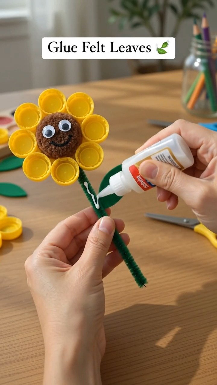 Bunte Flaschenverschlüsse zu einer hellen Sonnenblumen-Dekoration verwandeln, die jedem Raum einen fröhlichen handgemachten Akzent verleiht. Bewahre diese Idee für später auf.